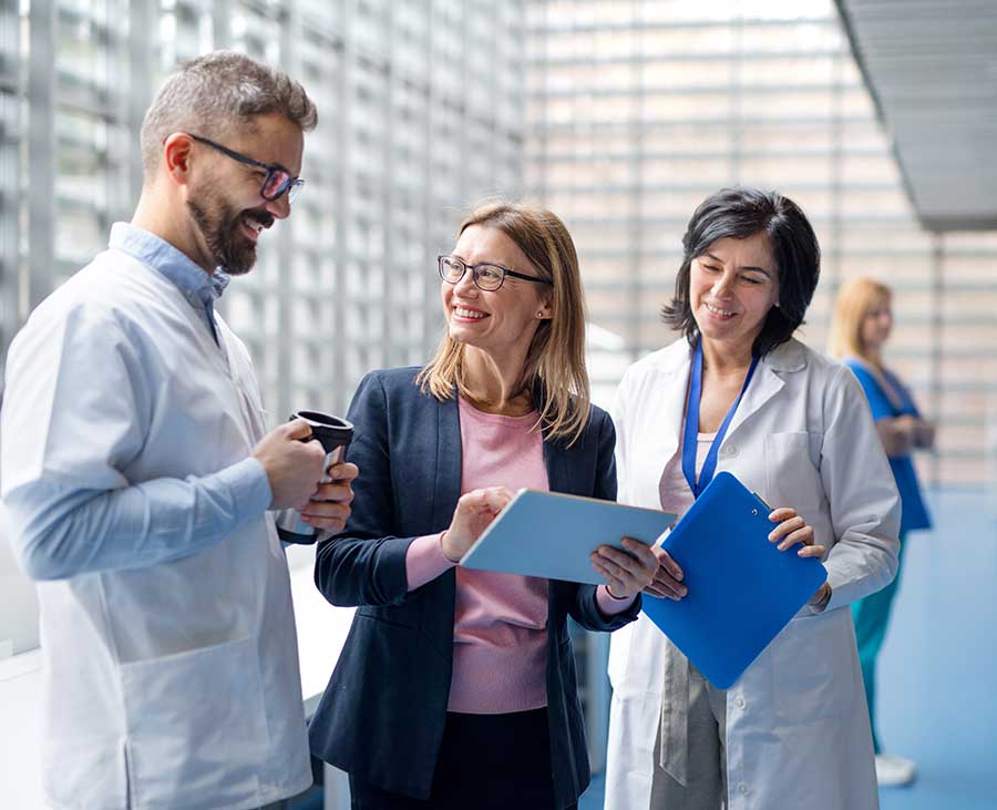 AdobeStock_327774848 Medical staff discussing items on a chart board