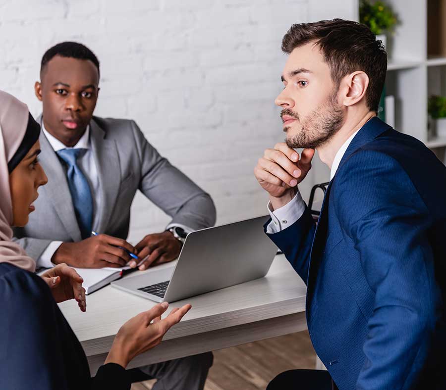 shutterstock_1895122114 Arab lady, African male and white man in office meeting