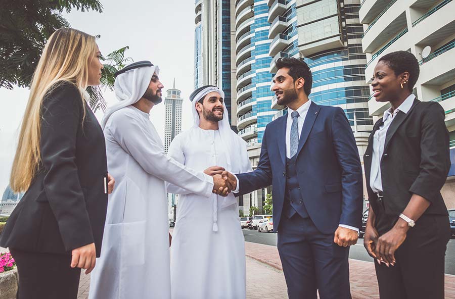 Arabic people handshake with people in suits 