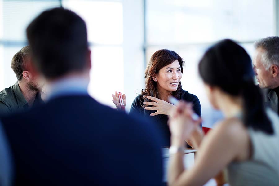 Chinese-Translation Chinese people talking at meeting with hands gesturing