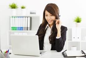 Woman at computer with headset